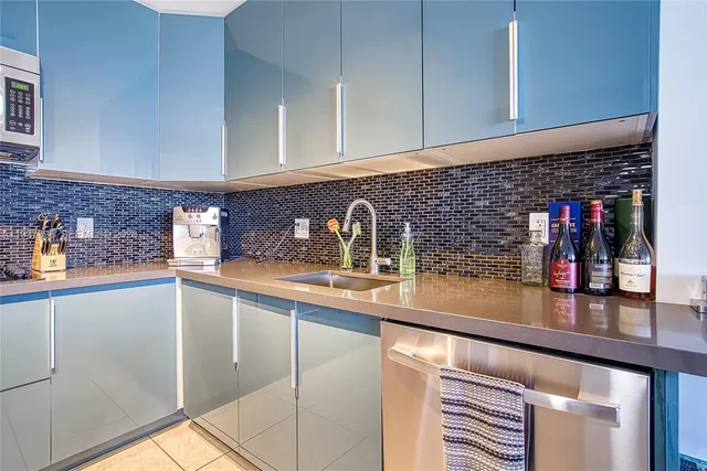 a kitchen with stainless steel appliances a sink a stove and a microwave