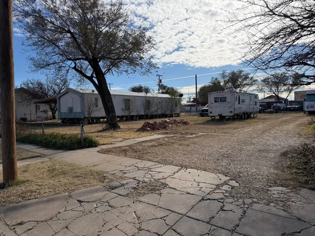 a view of a yard with cars