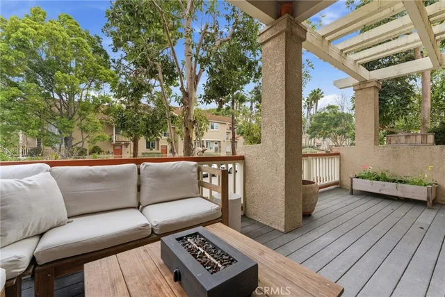 a view of a couches in the patio with potted plants