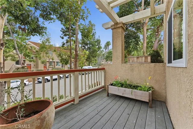 a view of balcony with wooden floor and outdoor seating