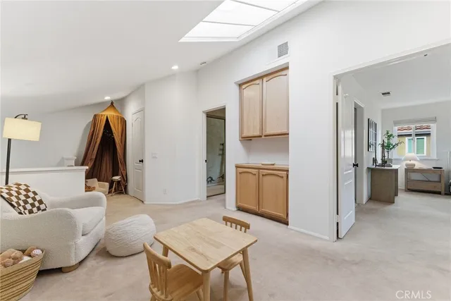 a living room with furniture and a view of bathroom