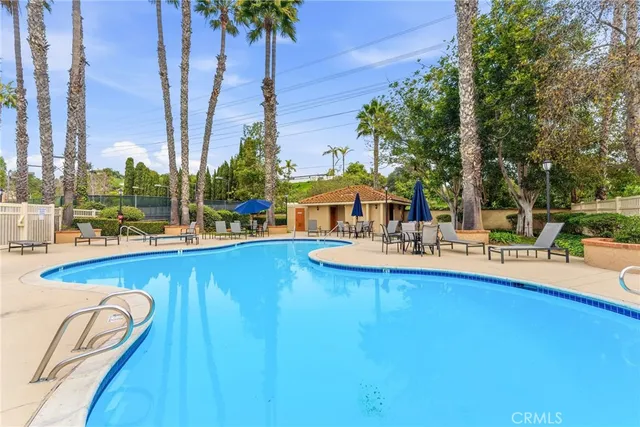 a swimming pool with outdoor seating and yard