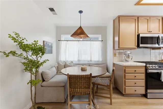a kitchen with a chair and a potted plant
