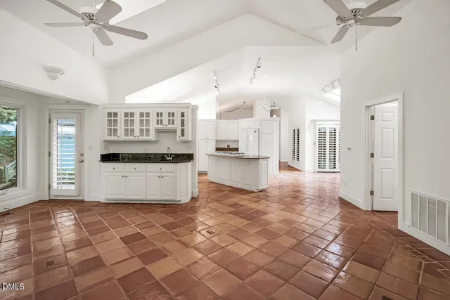 a large kitchen with cabinets and stainless steel appliances