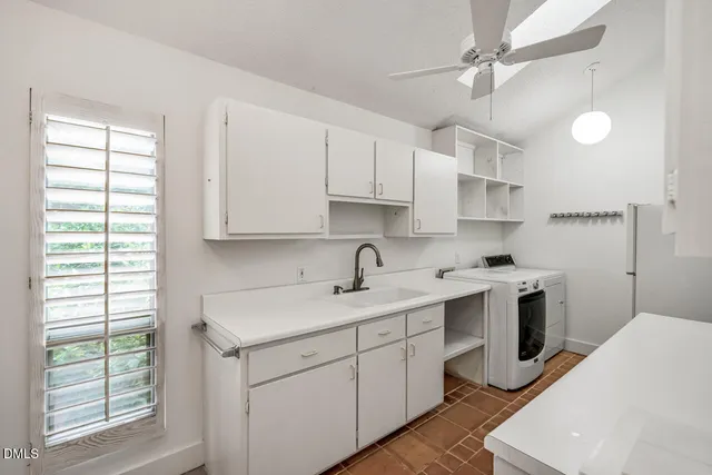 a kitchen with a sink a stove and cabinets