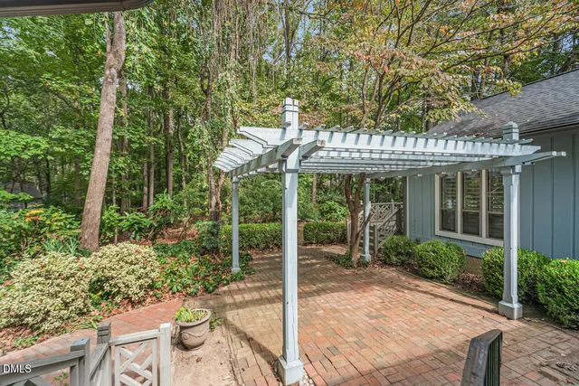 a view of a porch with furniture and garden