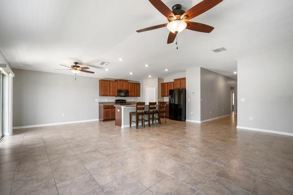 9607 Lemon Drop Loop Ruskin, FL 33573 - Photo 7 of 31 a view of a livingroom with furniture and a ceiling fan
