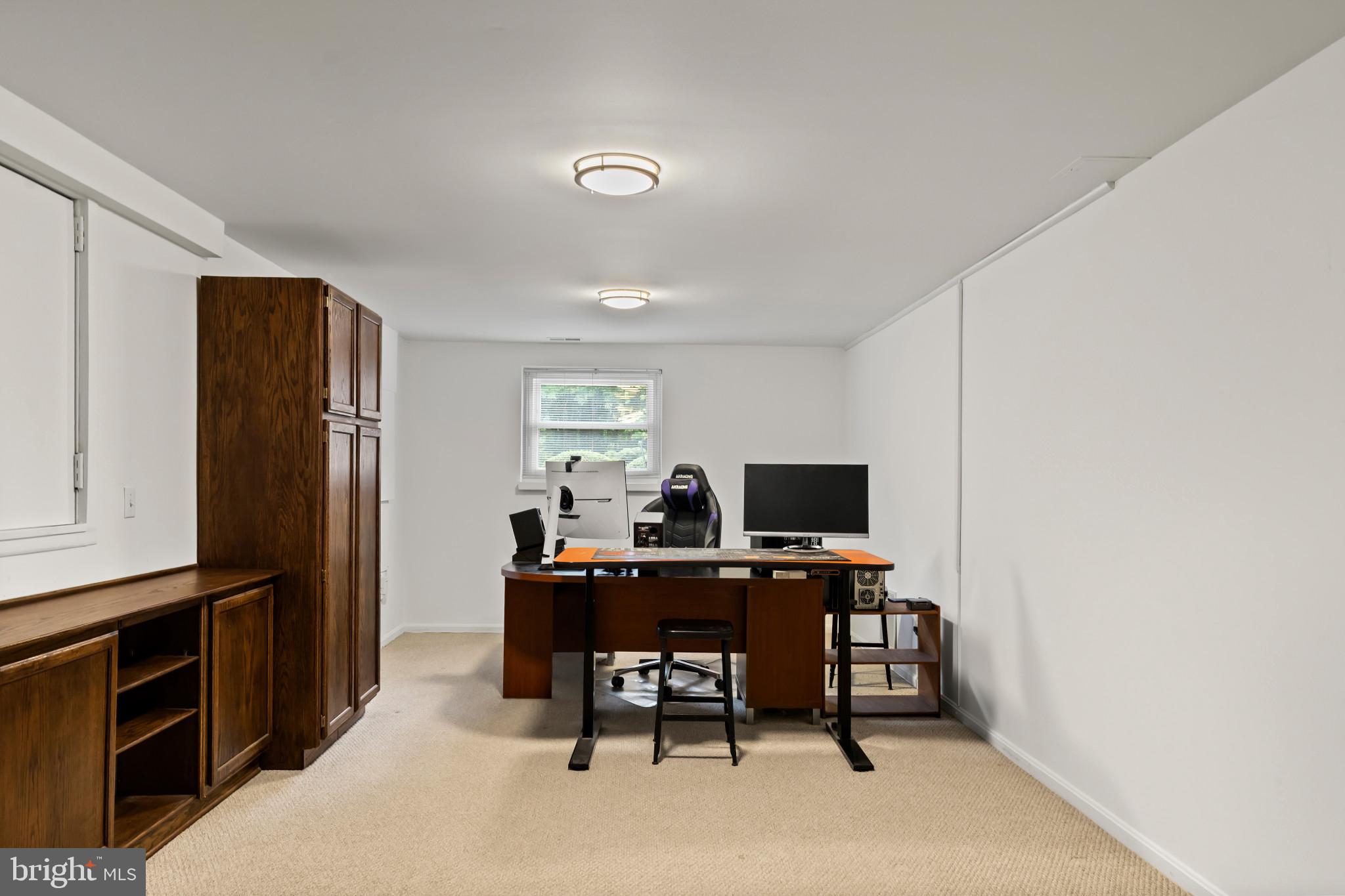 10821 Braeburn Road Columbia, MD 21044 - Photo 49 of 64 a view of a workspace with furniture and a window