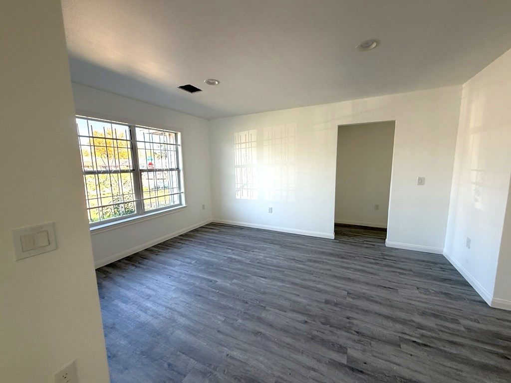 7430 Claiborne Street Houston, TX 77016 - Photo 11 of 23 an empty room with wooden floor and windows