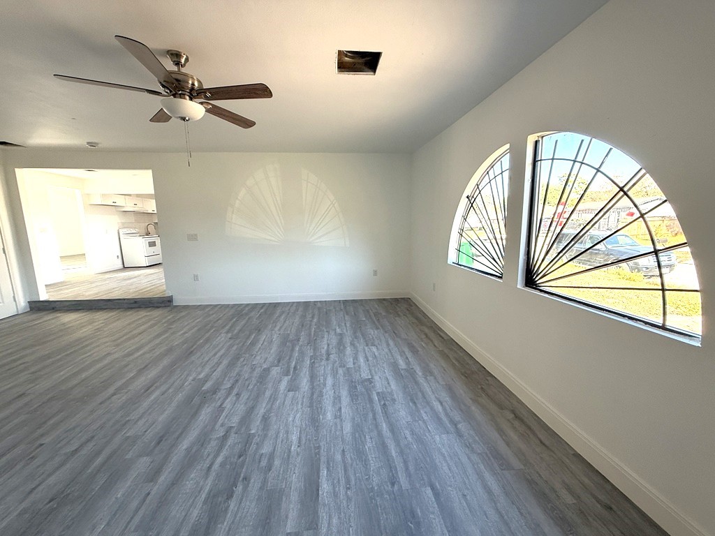 7430 Claiborne Street Houston, TX 77016 - Photo 13 of 23 wooden floor in an empty room with a window