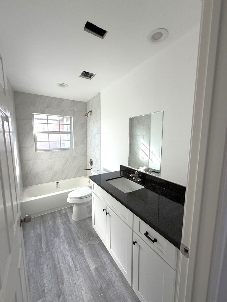 7430 Claiborne Street Houston, TX 77016 - Photo 14 of 23 a kitchen with granite countertop a sink and a toilet