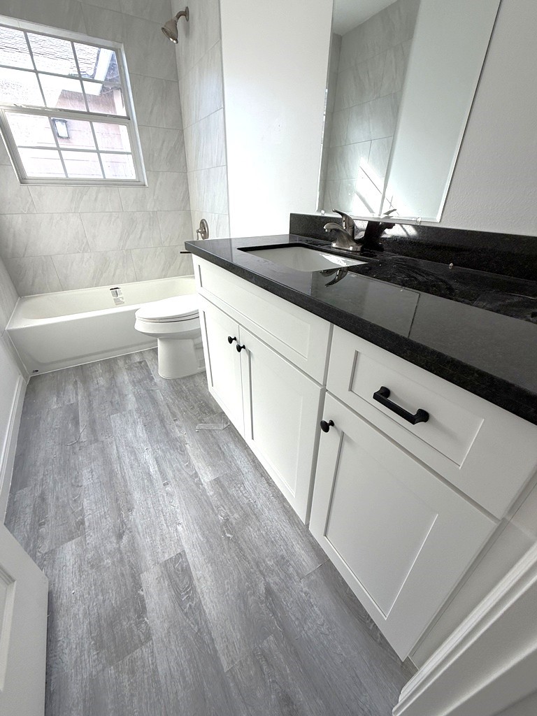7430 Claiborne Street Houston, TX 77016 - Photo 15 of 23 a kitchen with a sink a stove and cabinets