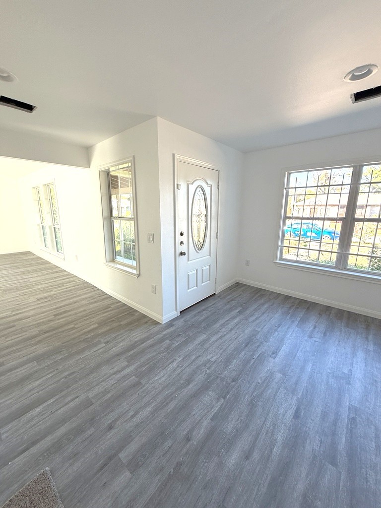 7430 Claiborne Street Houston, TX 77016 - Photo 16 of 23 an empty room with wooden floor and windows