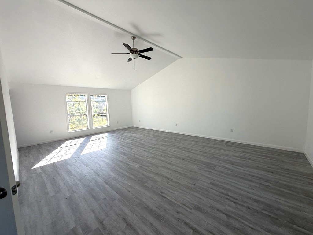 7430 Claiborne Street Houston, TX 77016 - Photo 4 of 23 an empty room with wooden floor fan and windows