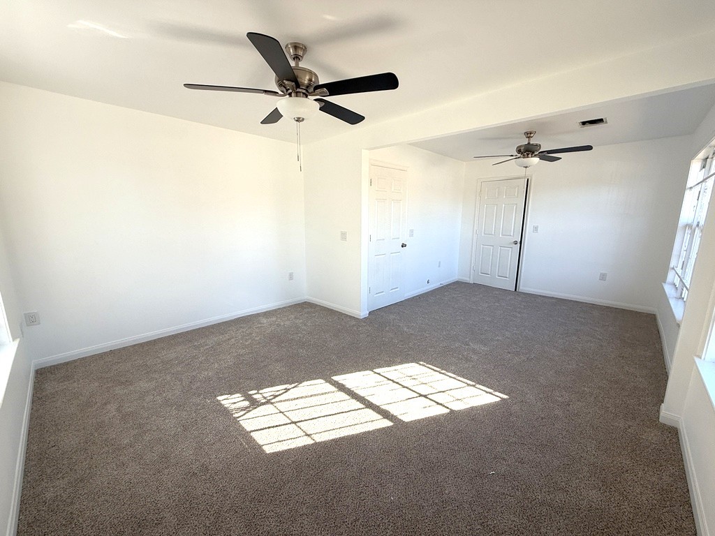7430 Claiborne Street Houston, TX 77016 - Photo 8 of 23 a view of a room with wooden floor and a ceiling fan