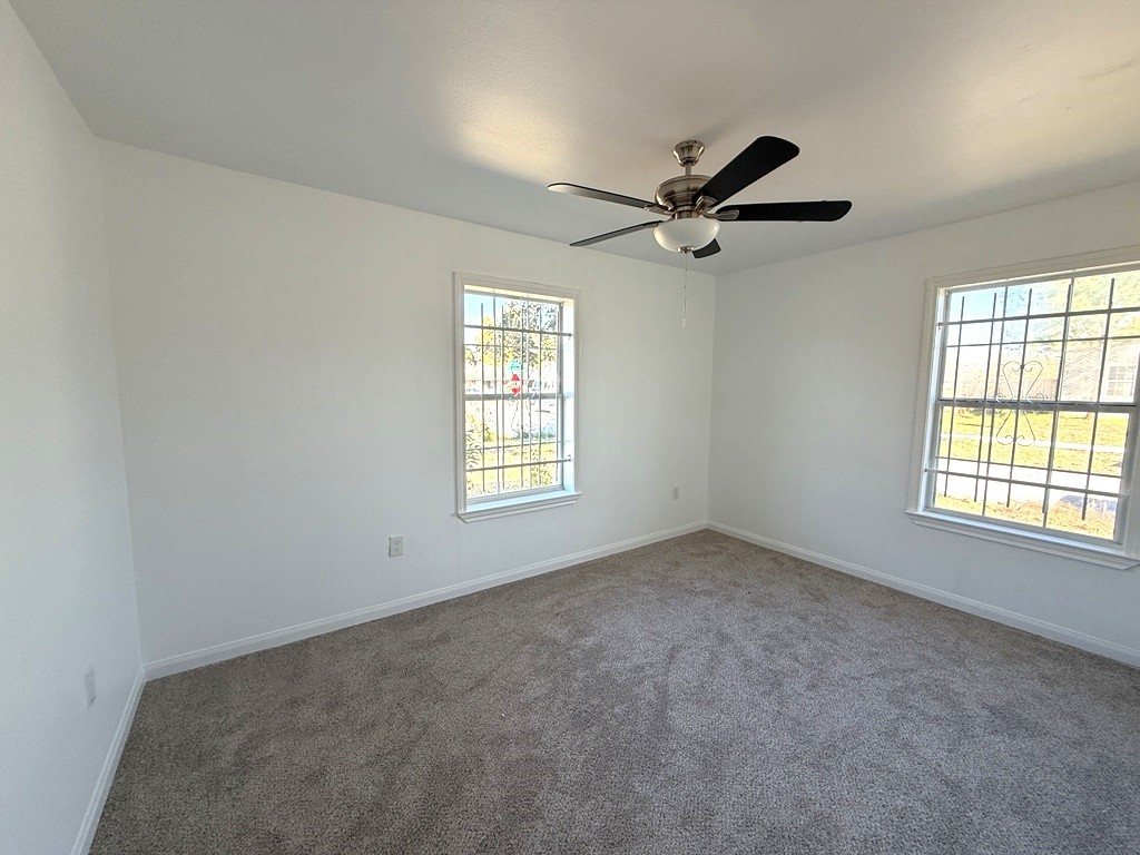 7430 Claiborne Street Houston, TX 77016 - Photo 9 of 23 an empty room with a window and a fan
