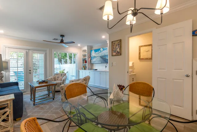 a dining room with furniture a chandelier and wooden floor