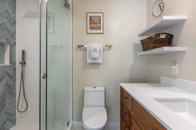 a bathroom with a toilet and a shower