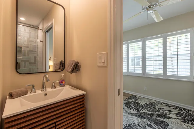 a porch with a table and chairs under an umbrella