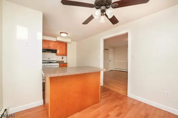 a open kitchen with a wooden floor