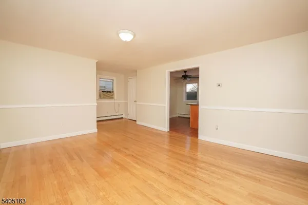 an empty room with wooden floor and closet