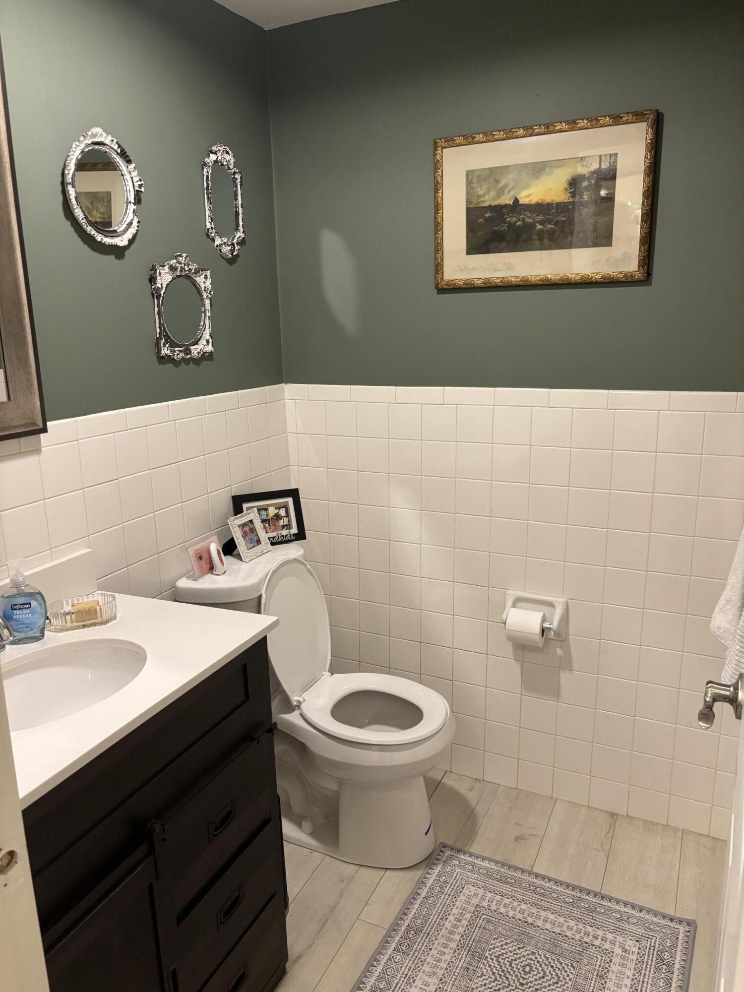 300 Falmouth Road, Unit 2C Mashpee, MA 02649 - Photo 7 of 14 a bathroom with a sink a toilet and a mirror