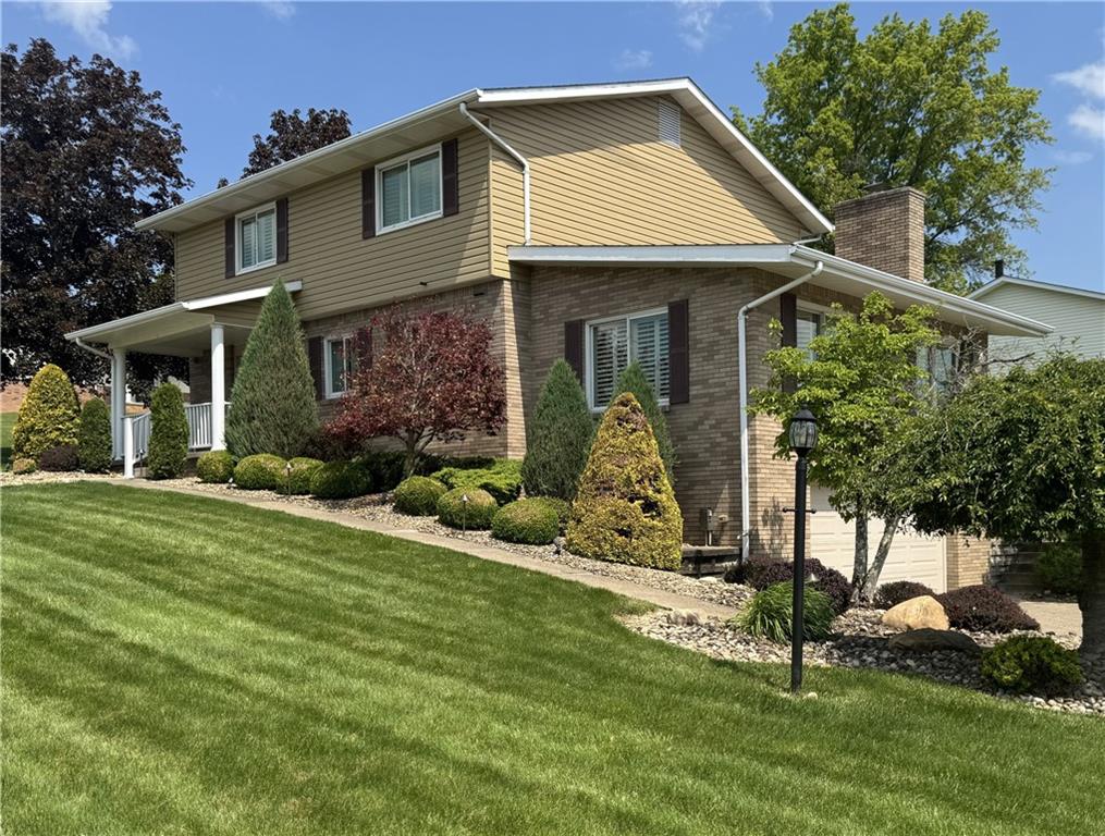 1313 Cross Street Rostraver Township, PA 15012 - Photo 1 of 49 a front view of a house with a garden