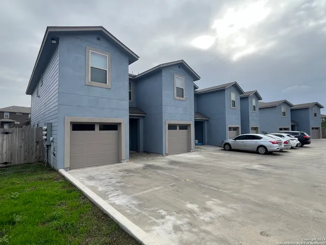 a view of a house with a yard and garage