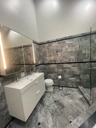 a bathroom with a sink toilet and shower