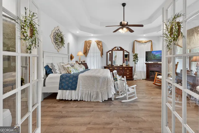 a bedroom with a bed and a chandelier