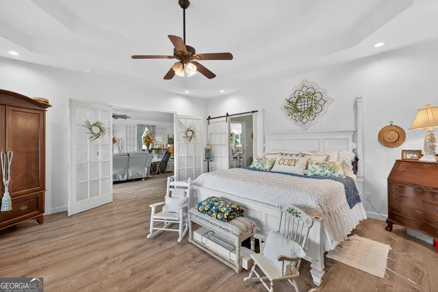 a bedroom with a bed and a chandelier