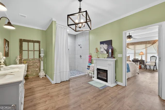 a view of a livingroom with furniture a flat screen tv and fireplace