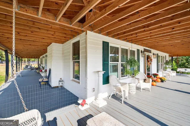 a view of a patio with table and chairs and wooden floor