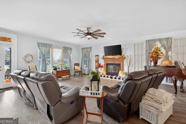 a living room with furniture a fireplace and a flat screen tv