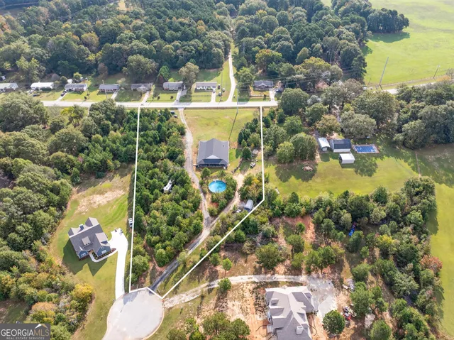 an aerial view of a house with a swimming pool yard and outdoor seating