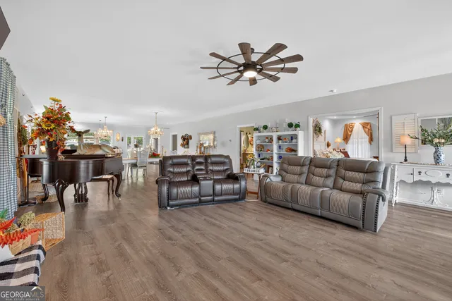 a living room with furniture and a wooden floor