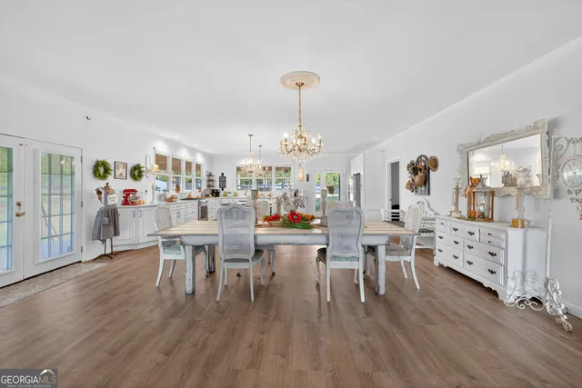 a view of a dining room with furniture wooden floor and chandelier
