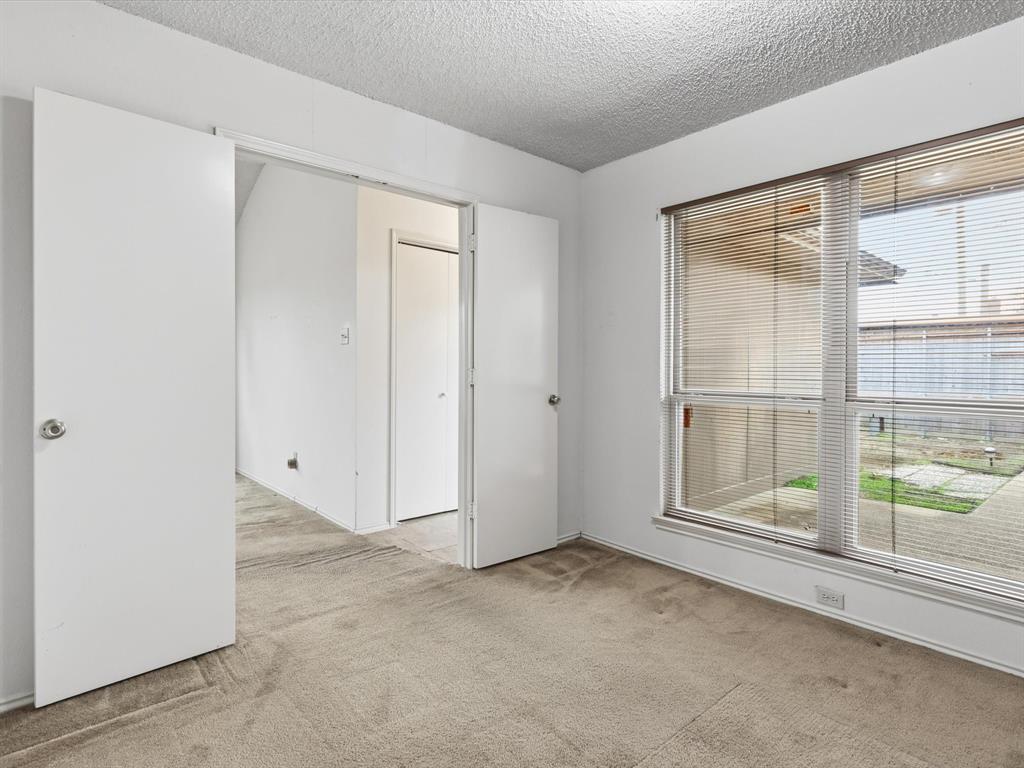 321 Gregory Lane Grand Prairie, TX 75052 - Photo 20 of 27 an empty room with sliding glass door