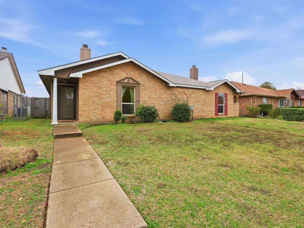 321 Gregory Lane Grand Prairie, TX 75052 - Photo 2 of 27 a front view of house with yard and green space