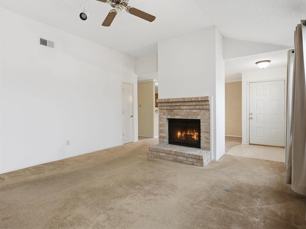 321 Gregory Lane Grand Prairie, TX 75052 - Photo 4 of 27 a view of an empty room with a fireplace