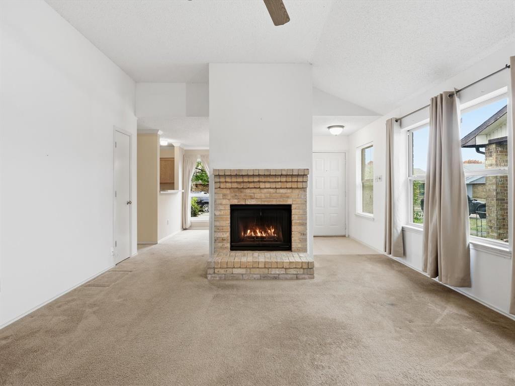 321 Gregory Lane Grand Prairie, TX 75052 - Photo 6 of 27 a living room with a fireplace