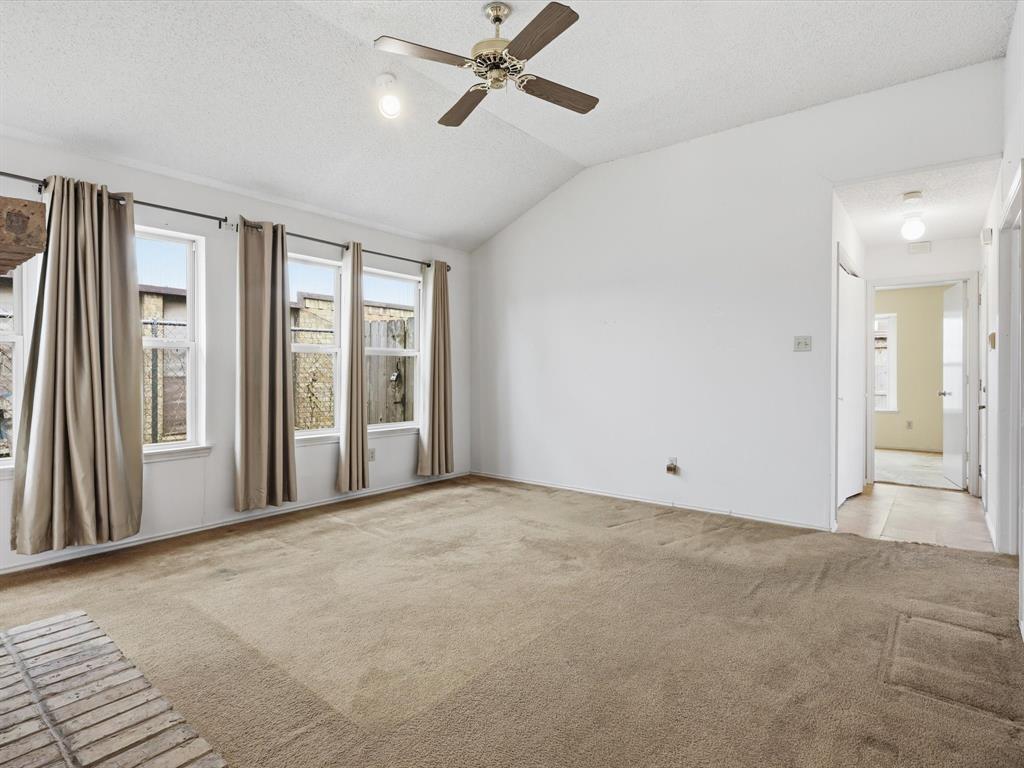 321 Gregory Lane Grand Prairie, TX 75052 - Photo 7 of 27 a view of an empty room with a window and a kitchen