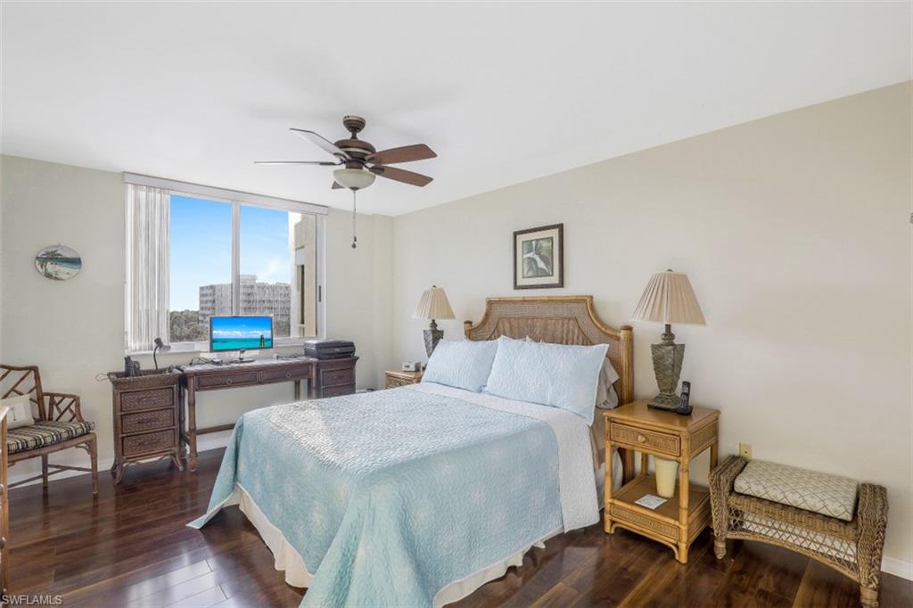 21 Bluebill Avenue, Unit B401 Naples, FL 34108 - Photo 13 of 23 a bedroom with a bed and a table in it