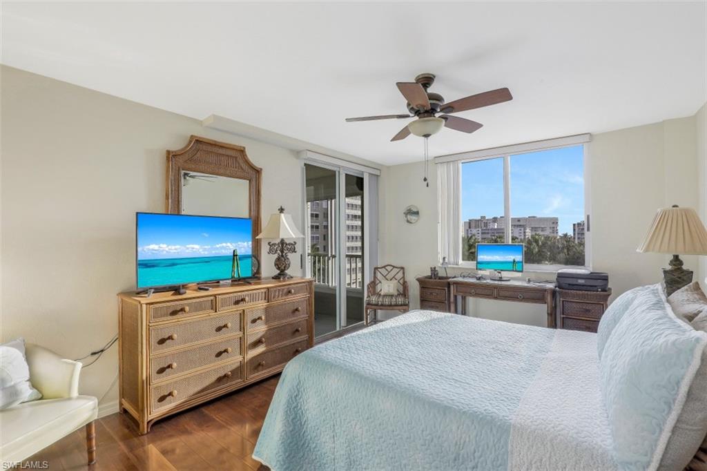 21 Bluebill Avenue, Unit B401 Naples, FL 34108 - Photo 14 of 23 a kitchen with stainless steel appliances kitchen island granite countertop a stove a sink a dining table and chairs with the wooden floor
