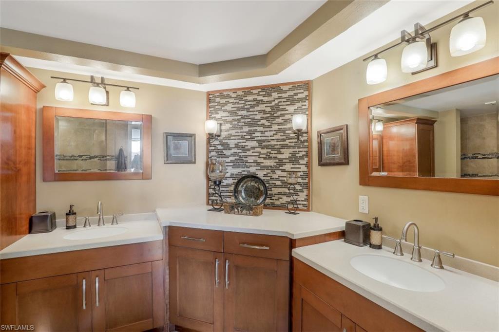 21 Bluebill Avenue, Unit B401 Naples, FL 34108 - Photo 15 of 23 a bathroom with a sink double vanity and a mirror