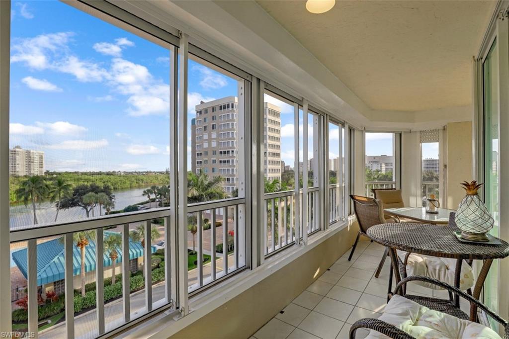 21 Bluebill Avenue, Unit B401 Naples, FL 34108 - Photo 21 of 23 a view of a city from a balcony with furniture