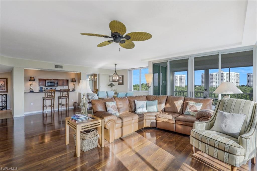 21 Bluebill Avenue, Unit B401 Naples, FL 34108 - Photo 4 of 23 a living room with furniture a ceiling fan and a window