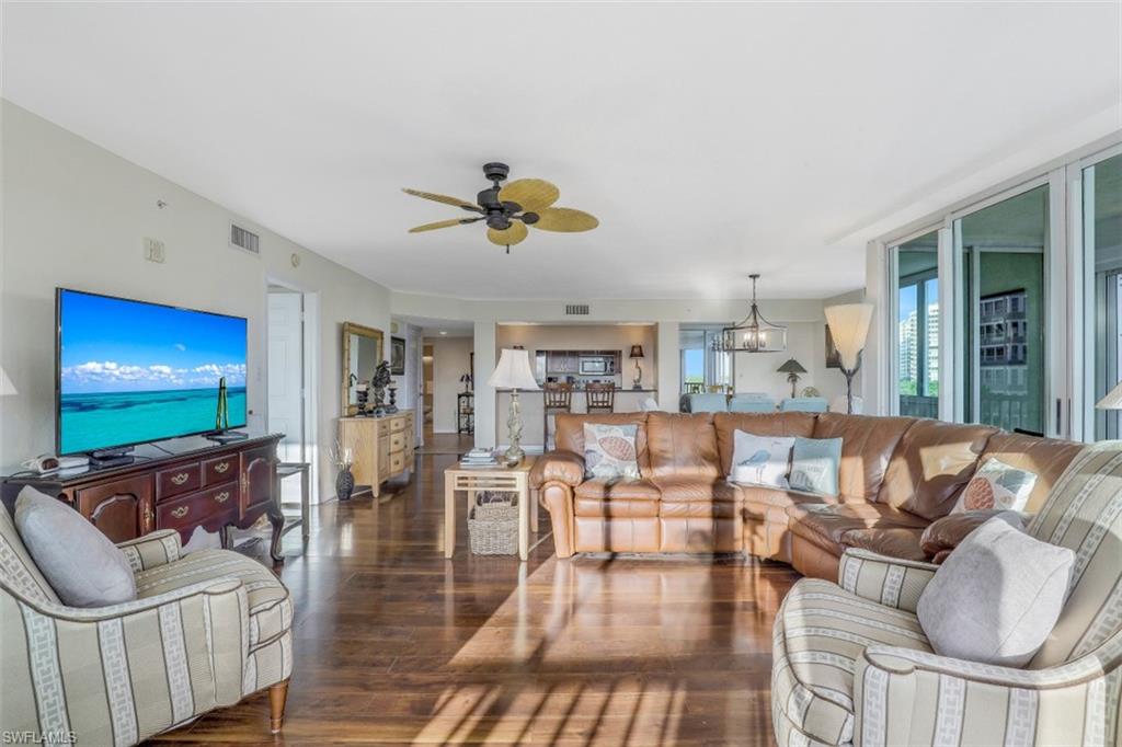 21 Bluebill Avenue, Unit B401 Naples, FL 34108 - Photo 5 of 23 a living room with furniture and a flat screen tv