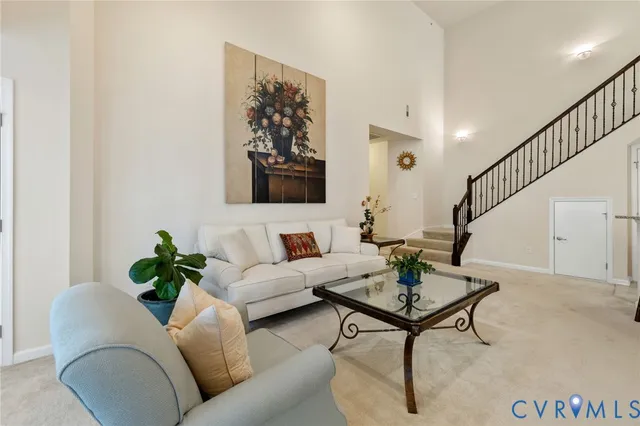 a living room with furniture a rug and a table