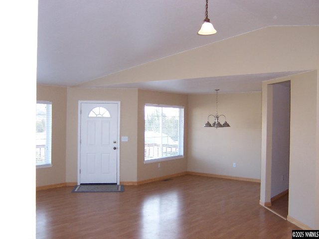 15071 Graham Lane Reno, NV 89508 - Photo 3 of 9 a view of an empty room with wooden floor and a window